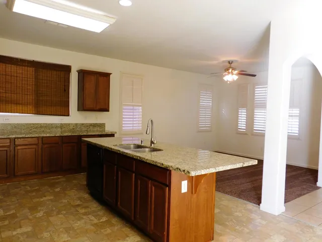 a kitchen with stainless steel appliances granite countertop a sink stove and cabinets