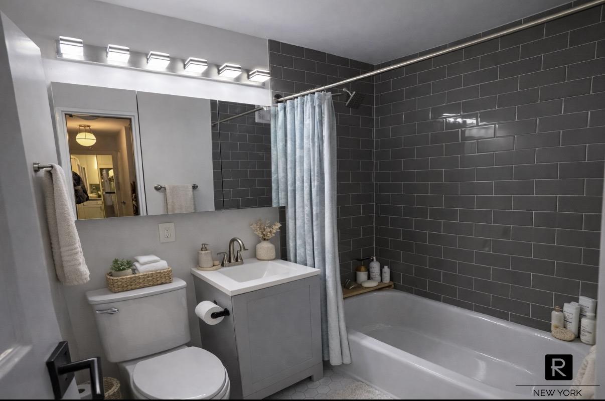 345 East 73rd Street, Unit 3F Manhattan, NY 10021 - Photo 4 of 9 a bathroom with a sink toilet and shower