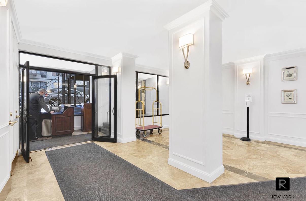 345 East 73rd Street, Unit 3F Manhattan, NY 10021 - Photo 6 of 9 a view of a hallway with wooden floor and livingroom