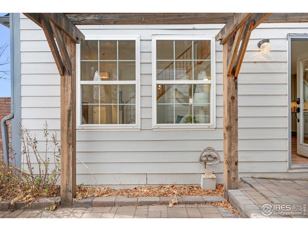 3109 Concord Way Longmont, CO 80503 - Photo 11 of 50 Step out to the private patio with a newer Pergola, brick pavers, a water feature and custom fencing