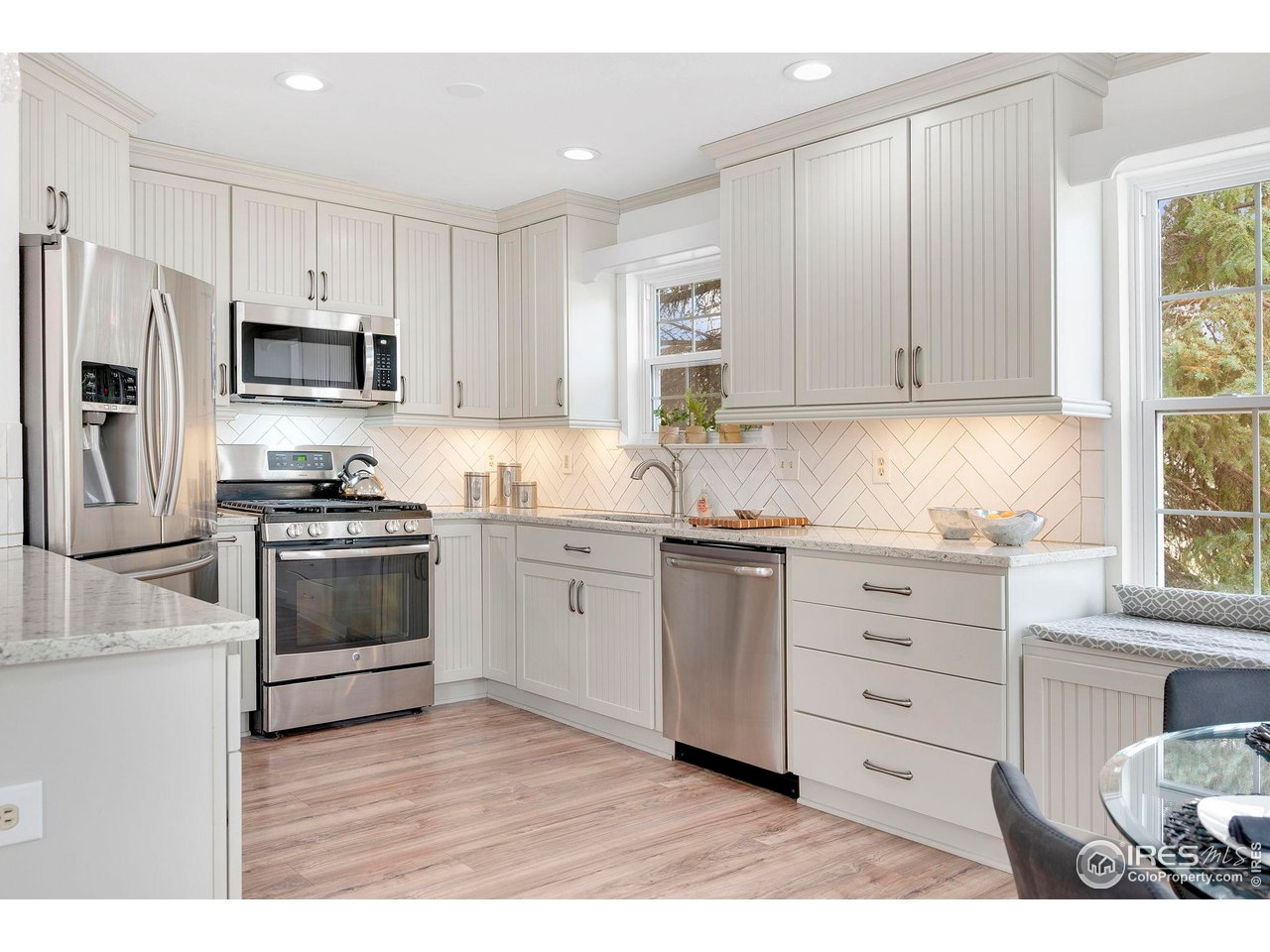 Marble countertops, engineered wood flooring and stainless steel appliances, including a gas range/oven, make for a wonderful cooking experience