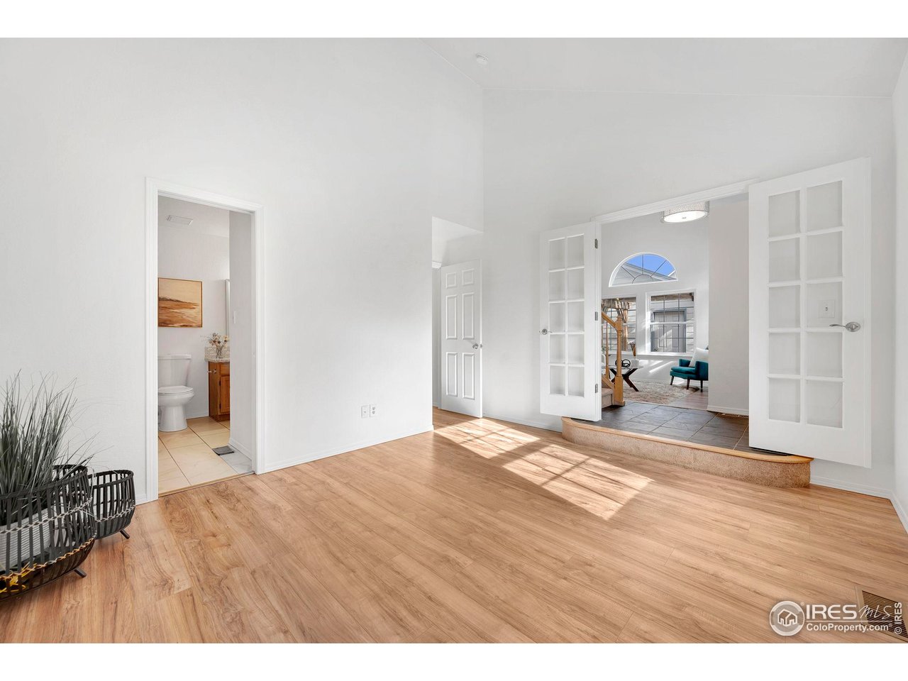 3109 Concord Way Longmont, CO 80503 - Photo 21 of 50 Bonus room has french doors with a jack and jill bathroom and laundry - shown unstaged