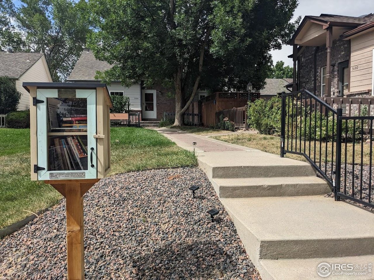 3109 Concord Way Longmont, CO 80503 - Photo 44 of 50 Summer view of the front of the home with Little Lending Library, what a great way to contribute to the community!
