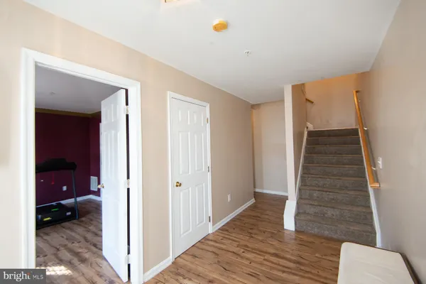 a living room with furniture and a lamp