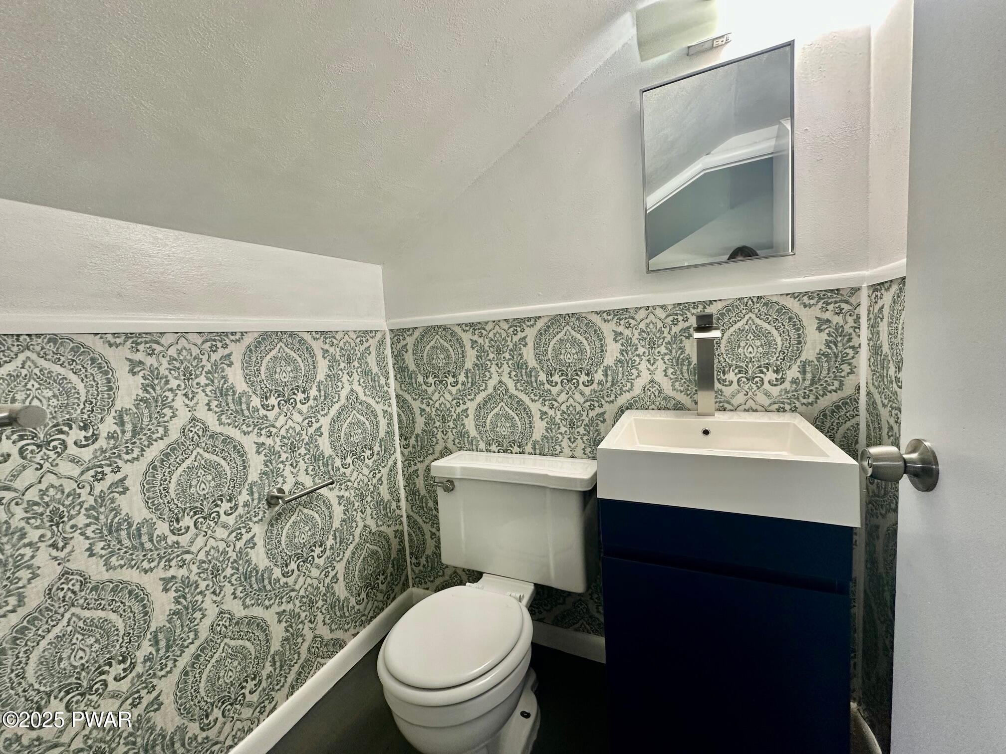 191 Hemlock Grove Road Greentown, PA 18426 - Photo 31 of 31 a bathroom with a sink toilet and mirror