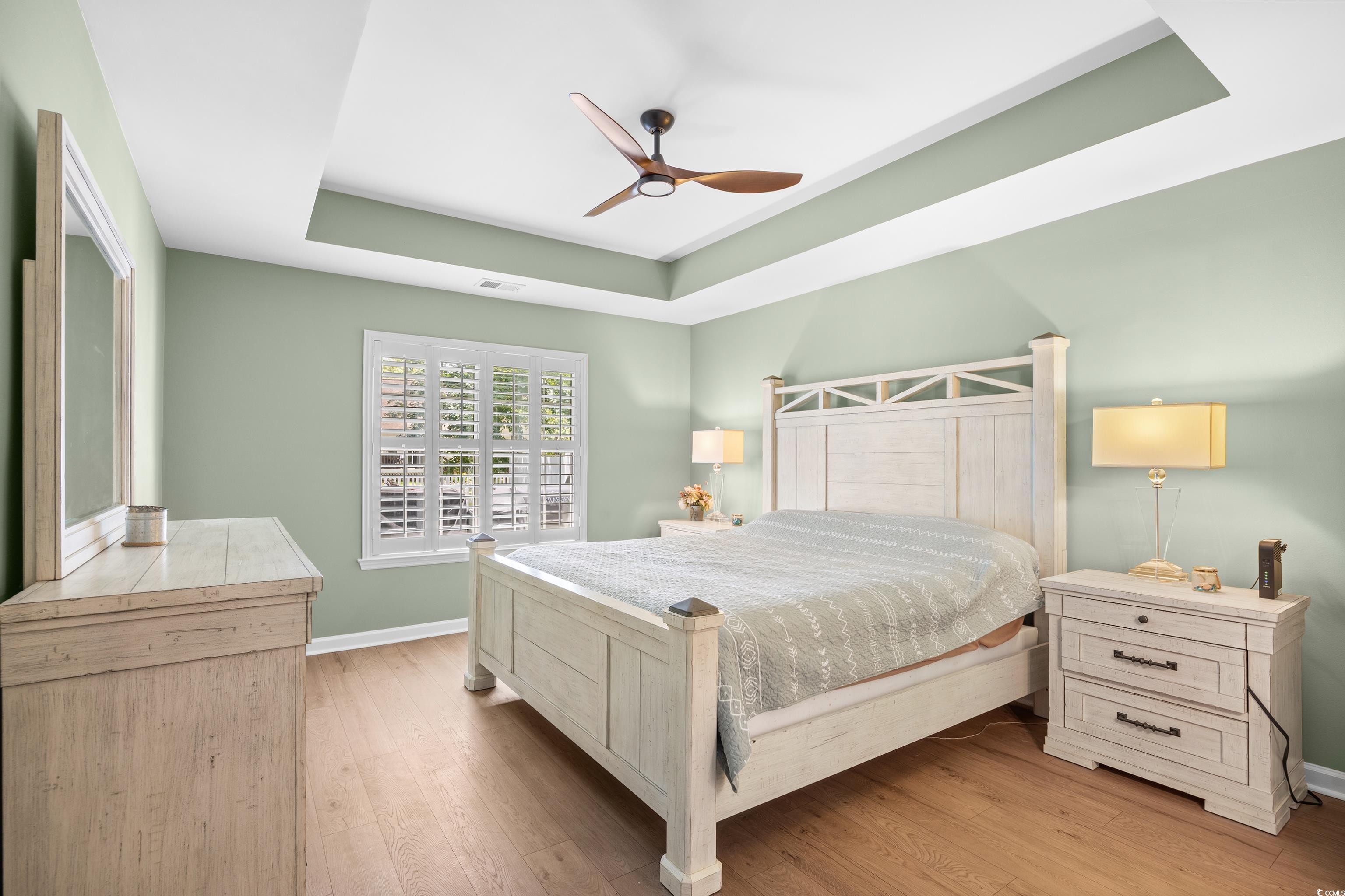 43 Reef Run Road Pawleys Island, SC 29585 - Photo 16 of 34 Bedroom featuring a raised ceiling, wood finished