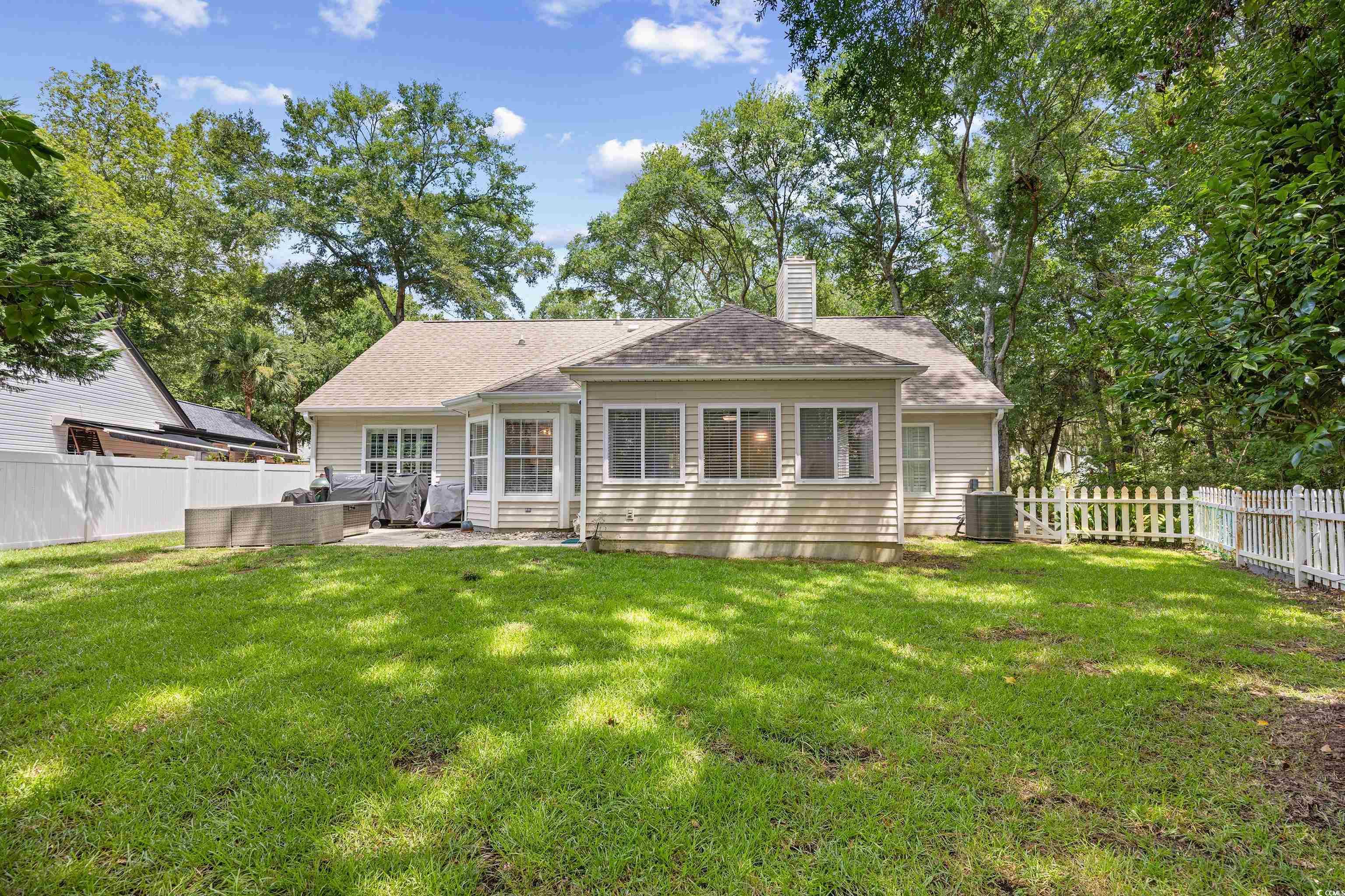 43 Reef Run Road Pawleys Island, SC 29585 - Photo 29 of 34 Rear view of house featuring a fenced backyard, a