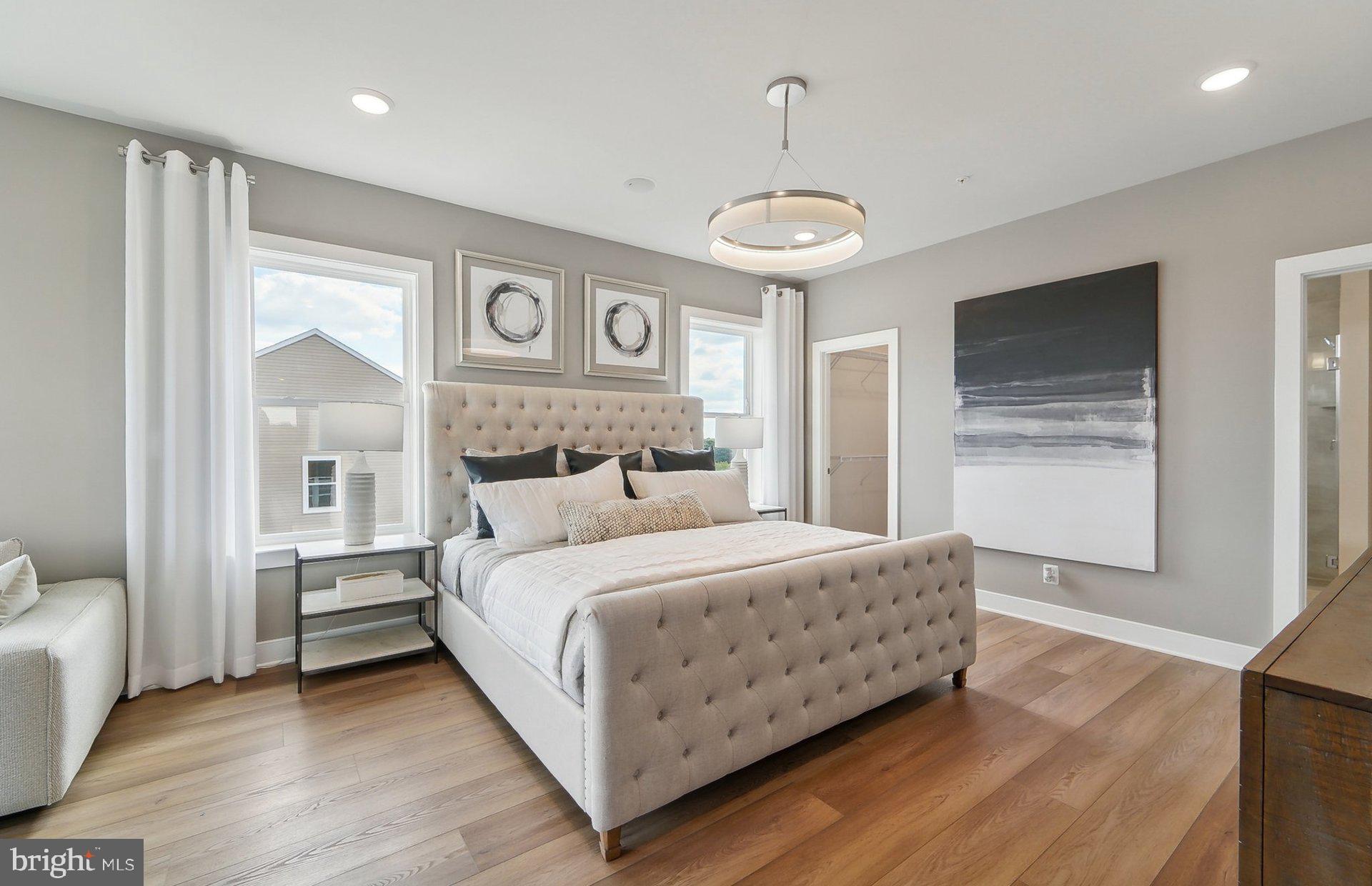 22521 Sculpin Brk Road Boyds, MD 20841 - Photo 21 of 52 a bedroom with a large bed and a chandelier