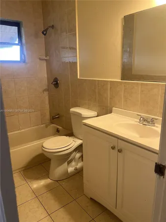 a bathroom with a toilet a sink and bathtub