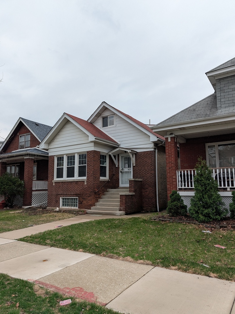 5041 West George Street Chicago, IL 60641 - Photo 2 of 11 a front view of a house with a yard and porch