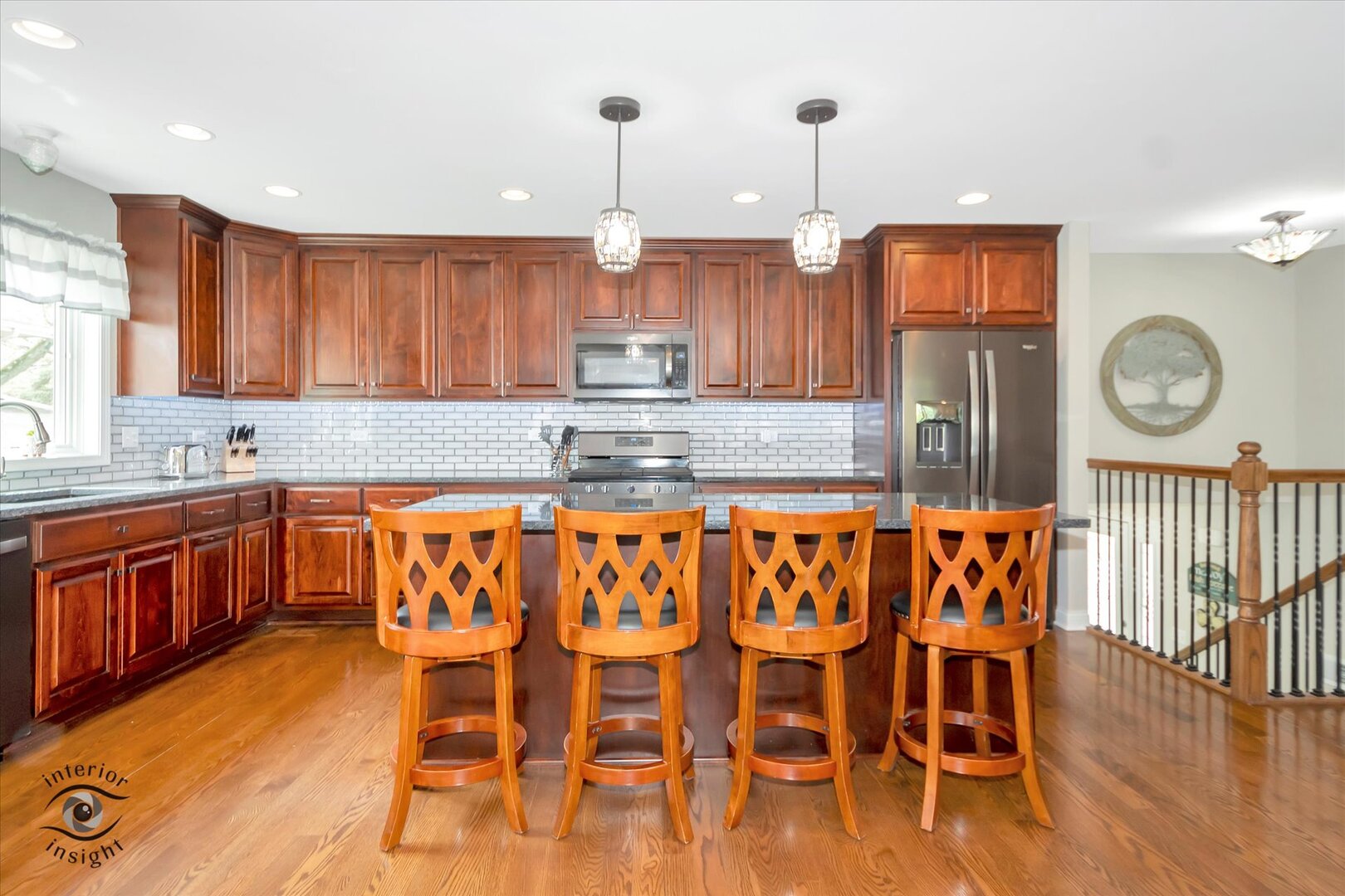 520 Hackberry Road Frankfort, IL 60423 - Photo 9 of 28 a kitchen with stainless steel appliances granite countertop a stove a sink and a dining table with wooden floor