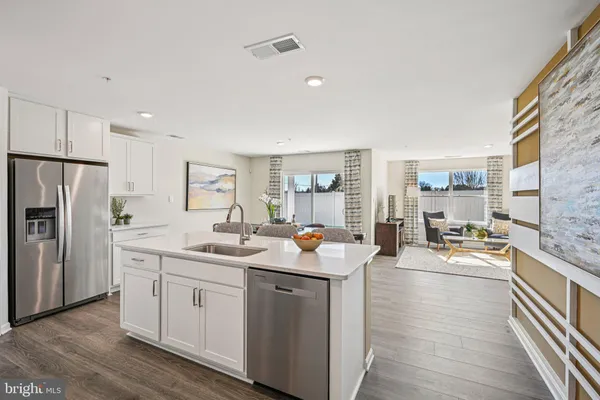 a kitchen with a sink stove and refrigerator
