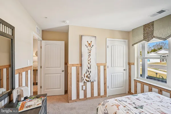 a bedroom with a bed and a dresser in it