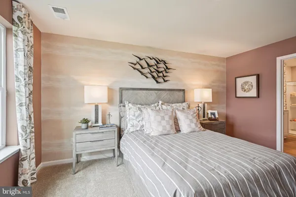a bedroom with a bed and a night stand