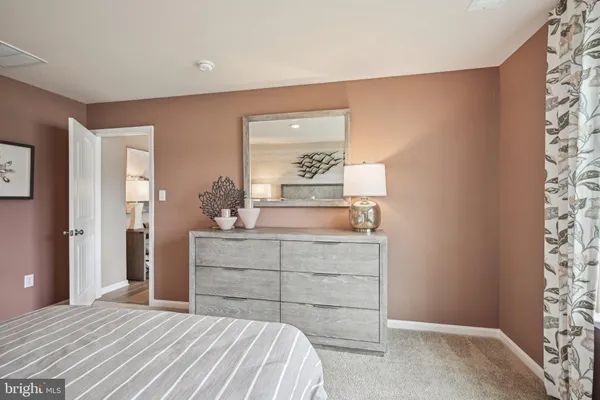 a bedroom with a bed and a dresser