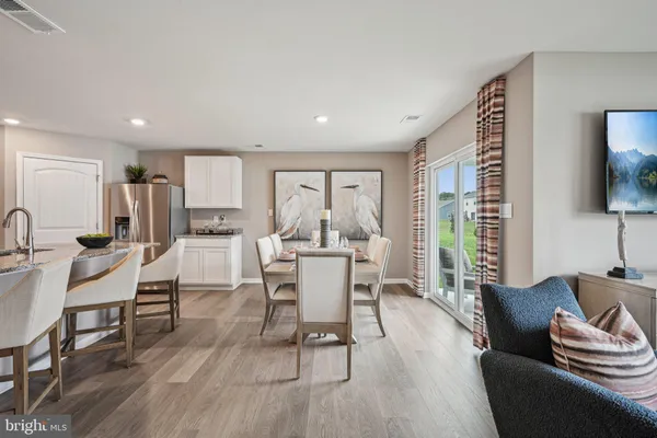 a dining room with furniture and wooden floor