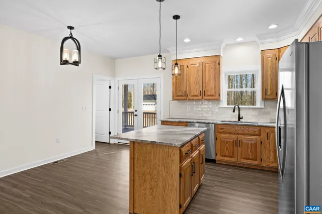 a kitchen with stainless steel appliances granite countertop a stove a sink and a microwave