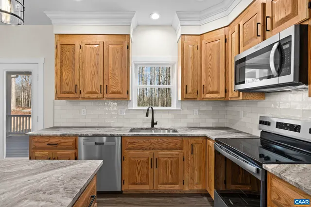 a kitchen with wooden cabinets and a stove top oven