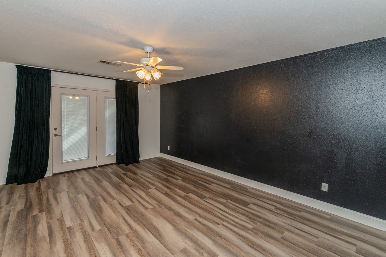 5975 Meadow Way Beaumont, TX 77707 - Photo 10 of 18 wooden floor in an empty room with a chandelier fan