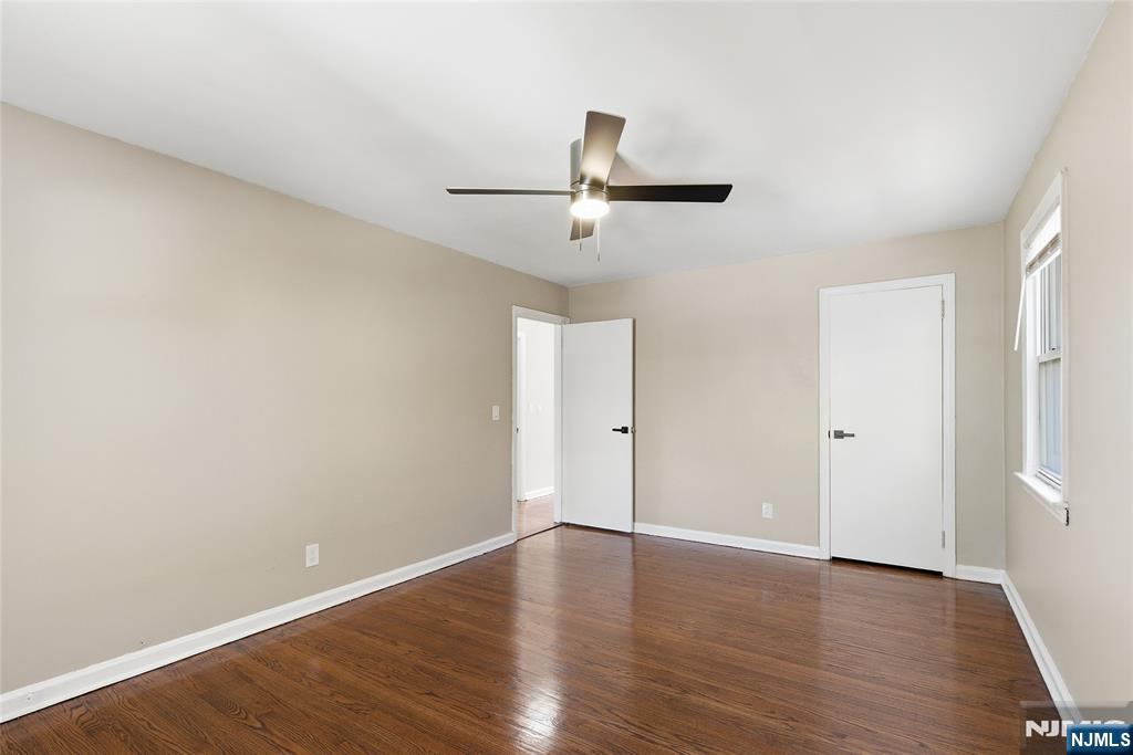 293 North Center Street, Unit 2 Orange, NJ 07050 - Photo 17 of 25 a view of a room with wooden floor and white walls