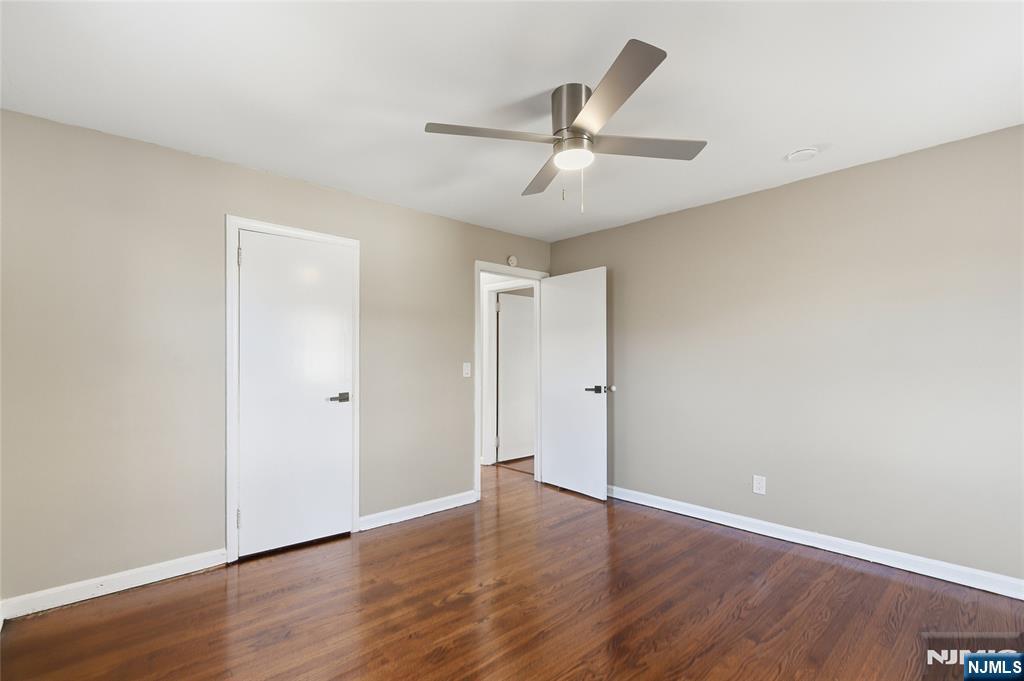 293 North Center Street, Unit 2 Orange, NJ 07050 - Photo 19 of 25 an empty room with wooden floor fan and windows