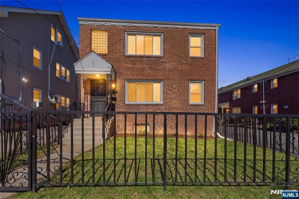 293 North Center Street, Unit 2 Orange, NJ 07050 - Photo 2 of 25 a view of a brick house with many windows