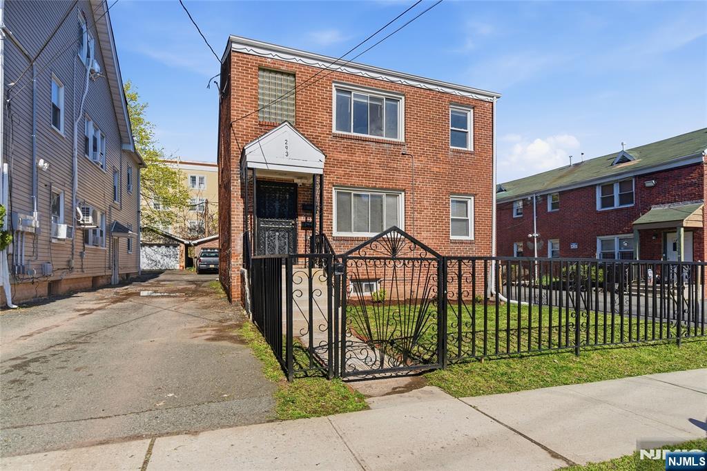 293 North Center Street, Unit 2 Orange, NJ 07050 - Photo 3 of 25 a view of a brick house in front of a yard