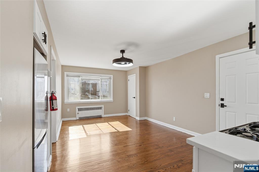 293 North Center Street, Unit 2 Orange, NJ 07050 - Photo 10 of 25 a view of a room with wooden floor and window