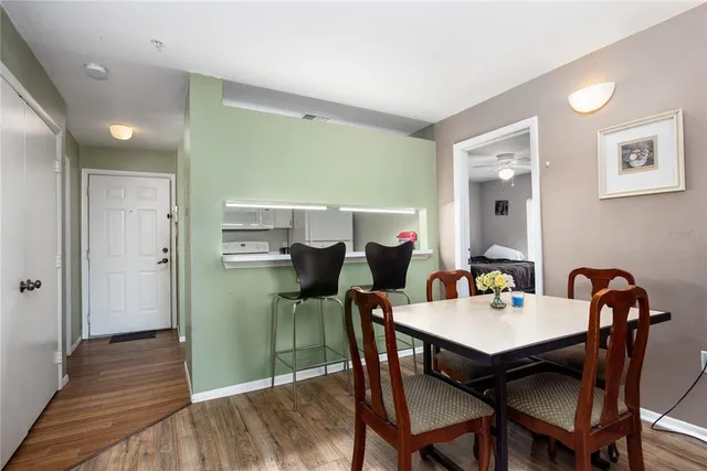 a dining room with furniture and wooden floor
