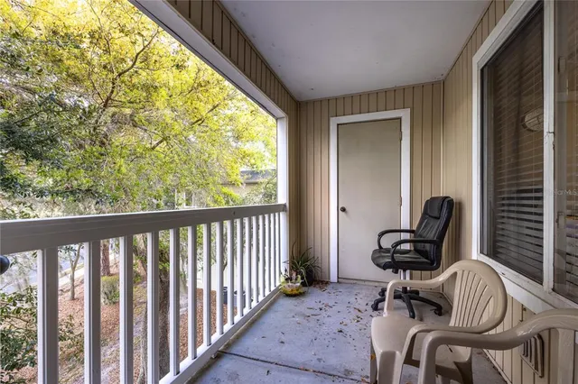 a view of a balcony with chair and swing