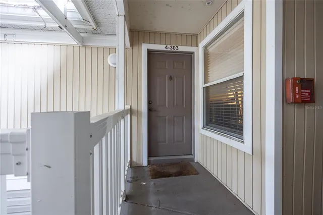 a view of a hallway with wooden floor and entryway