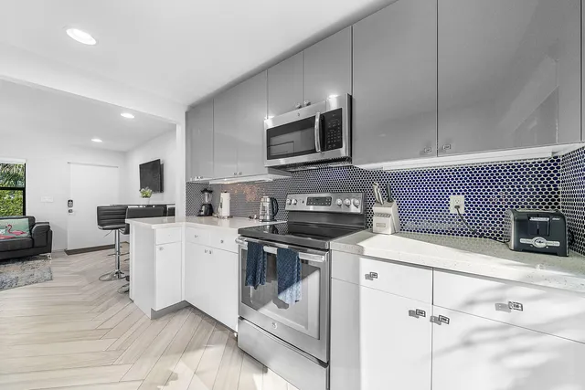 a kitchen with stainless steel appliances a refrigerator sink and stove