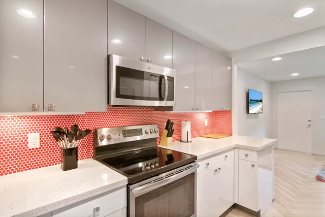 a kitchen with a sink stove and microwave