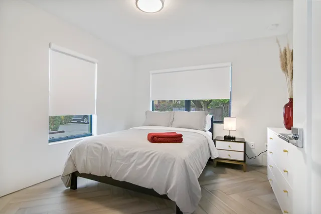 a bedroom with a bed and a window