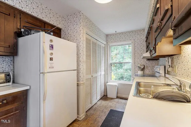 a white refrigerator freezer sitting inside of a kitchen
