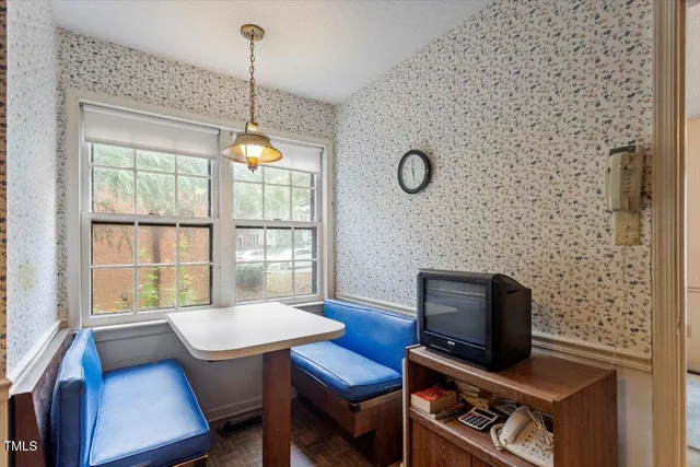 a view of a workspace with furniture and a window