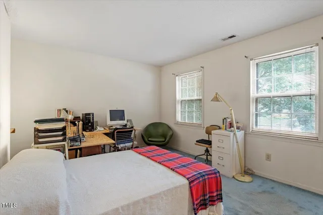a bedroom with two beds and a window