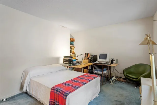 a bedroom with a bed and a desk