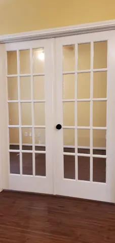 wooden floor in an empty room with a window