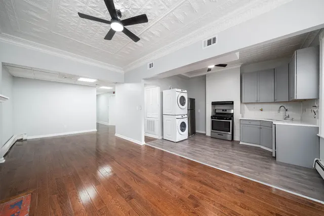a view of kitchen with sink microwave and refrigerator