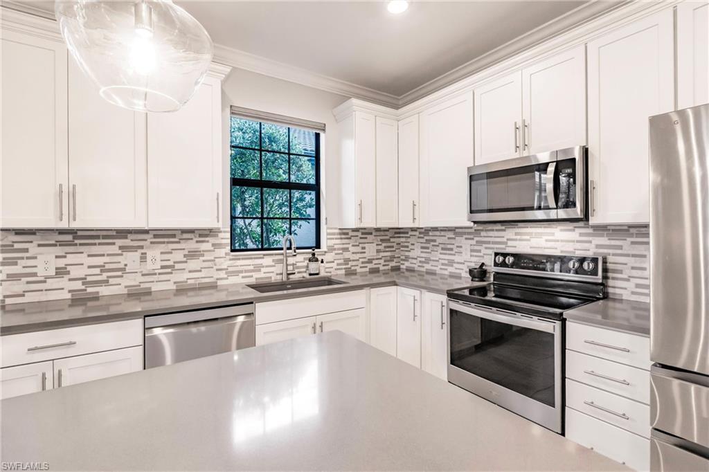 16637 Rolling Rock Boulevard Alva, FL 33920 - Photo 17 of 46 a kitchen with granite countertop a sink stainless steel appliances and cabinets
