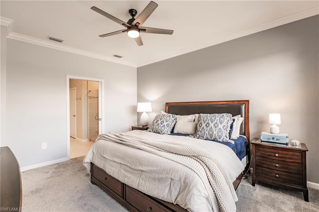 16637 Rolling Rock Boulevard Alva, FL 33920 - Photo 27 of 46 a bedroom with a bed and a ceiling fan