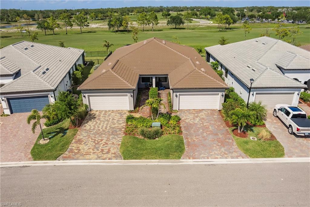 16637 Rolling Rock Boulevard Alva, FL 33920 - Photo 5 of 46 an aerial view of a house with a garden and lake view