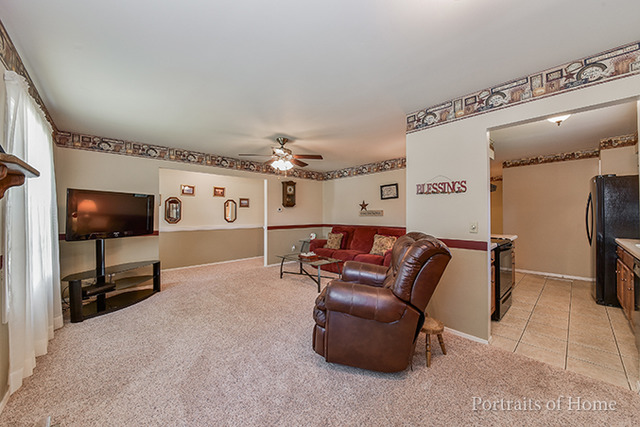 16 Pembrooke Road Montgomery, IL 60538 - Photo 3 of 16 a living room with furniture and a flat screen tv