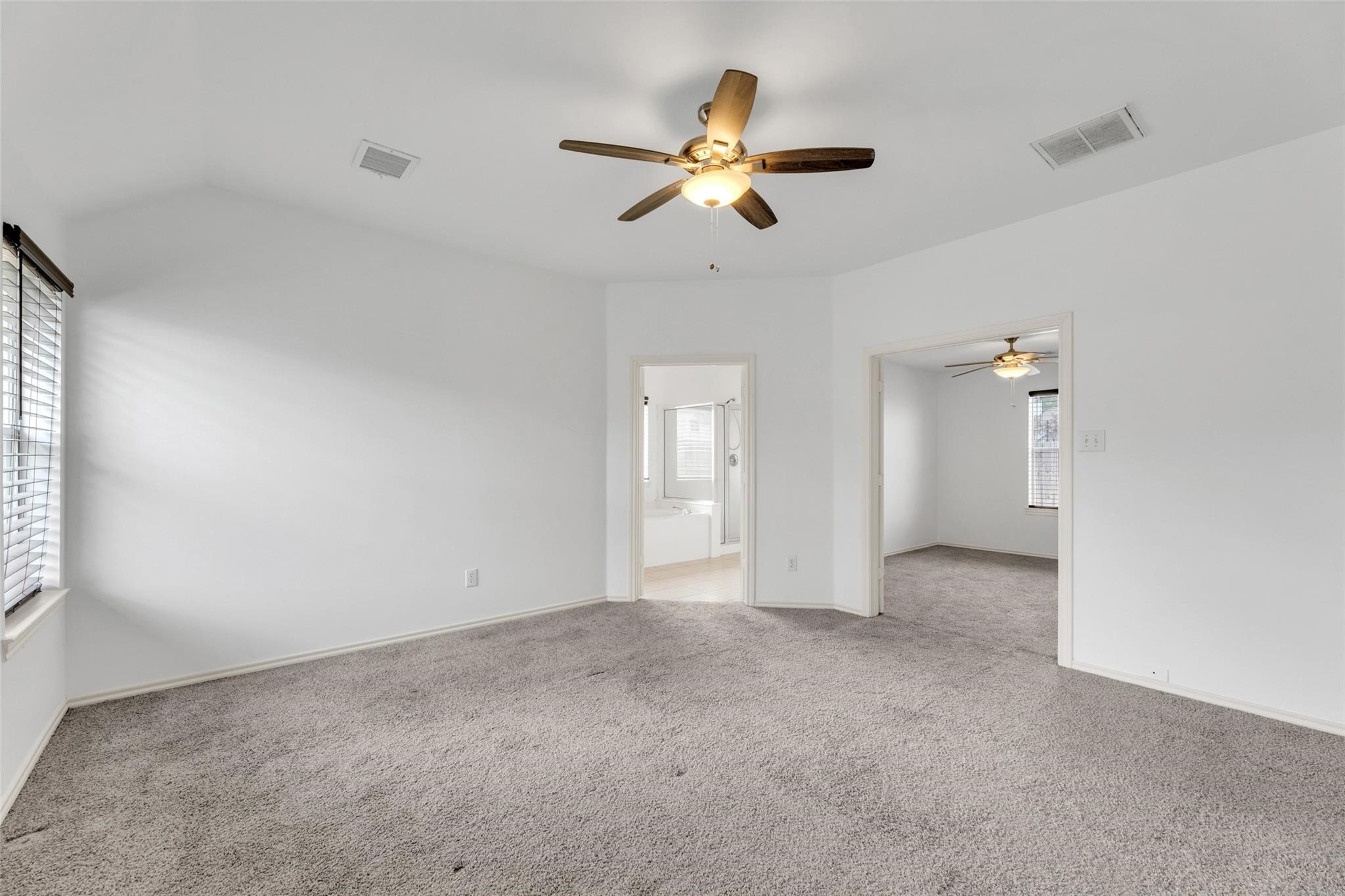 24523 Rathford Court Katy, TX 77494 - Photo 17 of 33 Spacious primary bedroom with a welcoming atmosphere and ample space for furnishings.