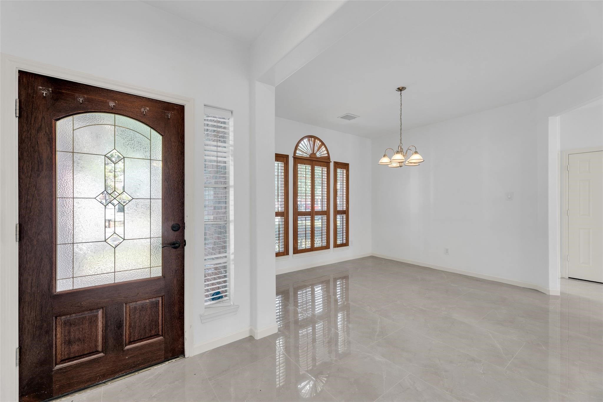 24523 Rathford Court Katy, TX 77494 - Photo 4 of 33 Bright and inviting entryway with direct access to the home’s elegant dining area.