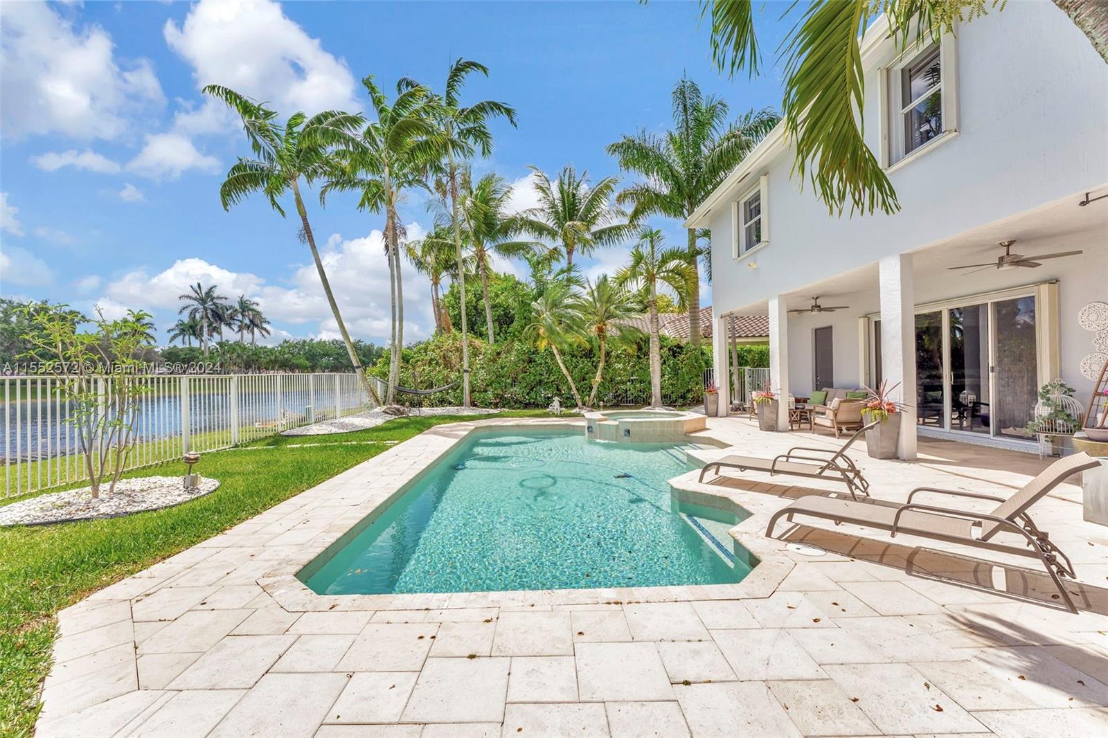 809 Regal Cove Road Weston, FL 33327 - Photo 12 of 70 a view of a backyard with swimming pool and sitting area