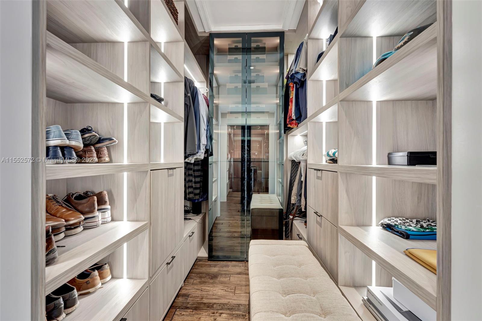 809 Regal Cove Road Weston, FL 33327 - Photo 23 of 70 a hallway with white cabinets and a wooden floor