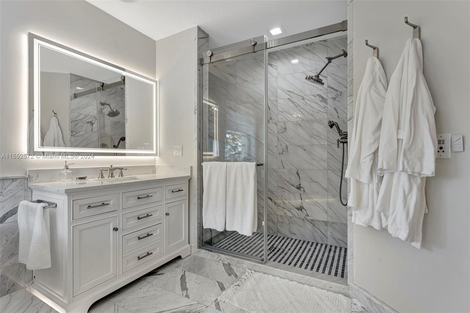 809 Regal Cove Road Weston, FL 33327 - Photo 26 of 70 a bathroom with a bathtub and a shower