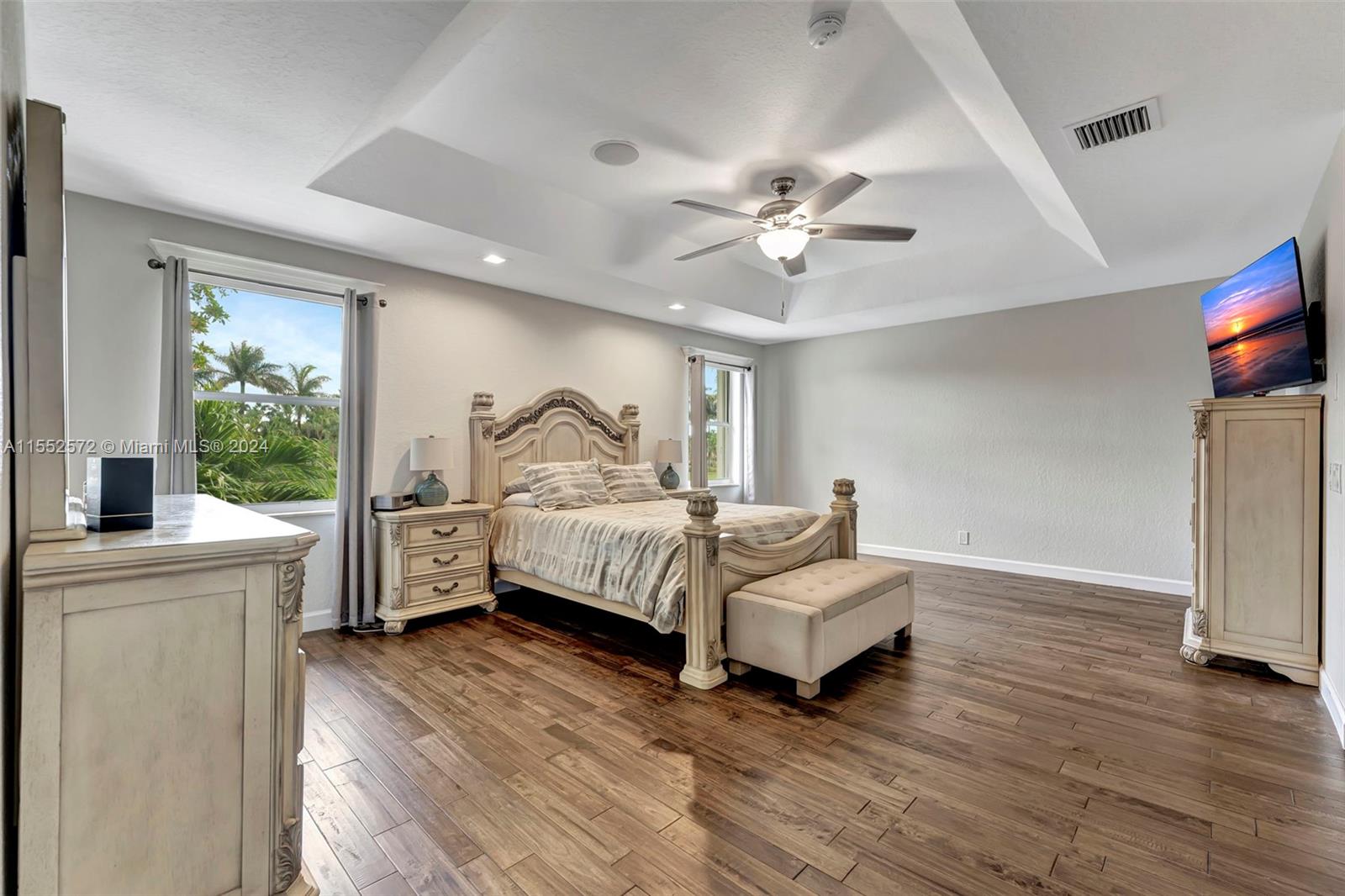 809 Regal Cove Road Weston, FL 33327 - Photo 29 of 70 a bedroom with a bed wooden floor and a ceiling fan